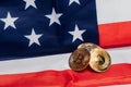 Different cryptocurrency coins on an United States flag.