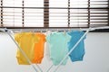 Different cute baby onesies hanging on clothes line . Laundry day Royalty Free Stock Photo