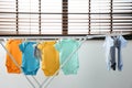 Different cute baby onesies hanging on clothes line. Laundry day Royalty Free Stock Photo