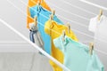 Different cute baby onesies and toy  hanging on clothes line. Laundry day Royalty Free Stock Photo