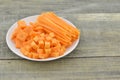 Different cuts of carrot in white plate on wooden rustic Royalty Free Stock Photo