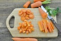 Different cuts of fresh carrot in board on wooden table Royalty Free Stock Photo