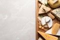 Different delicious cheeses  on grey table, top view. Space for text Royalty Free Stock Photo