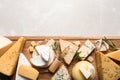 Different delicious cheeses served on grey table, top Space for text Royalty Free Stock Photo