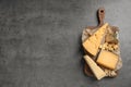 Different delicious cheeses served on grey table, top view Royalty Free Stock Photo