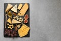 Different delicious cheeses served on grey table, top view. Space for Royalty Free Stock Photo