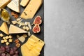 Different delicious cheeses served on  table, top view. Space for text Royalty Free Stock Photo