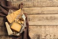 Different delicious cheeses served on wooden table, top view. Royalty Free Stock Photo