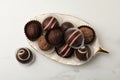 Different delicious chocolate truffles on white marble table, flat lay Royalty Free Stock Photo
