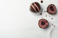 Different delicious chocolate truffles on white marble table, flat lay. Space for text Royalty Free Stock Photo