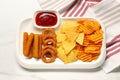 Different delicious fast food served with ketchup on white marble table, top view Royalty Free Stock Photo