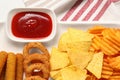 Different delicious fast food served with ketchup on white table, flat lay Royalty Free Stock Photo