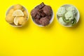 Different delicious ice creams on yellow background, flat lay. Space for text Royalty Free Stock Photo