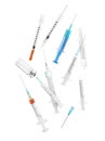 Different disposable syringes falling on white background. Medical equipment