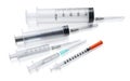 Different disposable syringes with needles on white background