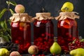Different of dogwood compote with peaches, pears and blackberries in jars on a dark background, horizontal orientation
