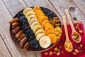 Different dried fruits on a plate on a wooden table Royalty Free Stock Photo