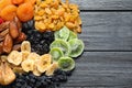 Different dried fruits on wooden background, top view with space for text. Royalty Free Stock Photo