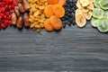 Different dried fruits on wooden background, top view with space for text. Royalty Free Stock Photo