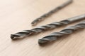 Different drill bits on wooden surface, closeup Royalty Free Stock Photo