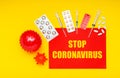 Different drugs, medicines tablets, pills, syringes against coronavirus, models of coronavirus, text on red banner Stop