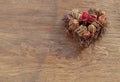 Different dry fruits over on twigs pile shape of heart on wooden background Royalty Free Stock Photo