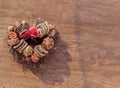 Different dry fruits over on on twigs pile shape of heart on wooden background Royalty Free Stock Photo