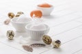 Different eggs with feathers for Easter on white background