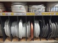 Different electric white cables. Wire wound into skeins and rings. Electric wires cable products samples in store