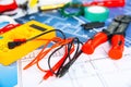 Different electrical tools on house plans, closeup Royalty Free Stock Photo