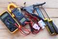 Different electrically operated tools isolated on wooden background closeup.