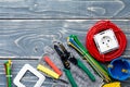 Different electrician`s supplies on gray wooden background Royalty Free Stock Photo