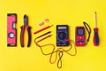 Different electrician`s supplies on yellow background. Background of professional electrician tools with space for text Royalty Free Stock Photo