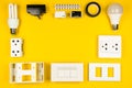 Different electrician's supplies on yellow background. Background of professional electrician tools with space for text. Royalty Free Stock Photo