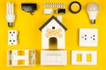 Different electrician's supplies on yellow background. Background of professional electrician tools with space for text. Royalty Free Stock Photo