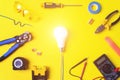 Different electrician`s supplies on yellow background. Background of professional electrician tools with space for text and Royalty Free Stock Photo