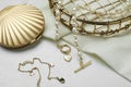 Different elegant jewelry and cosmetic pocket mirror on white table, closeup
