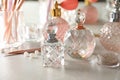 Different elegant perfume bottles on table