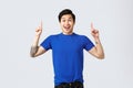Different emotions, people lifestyle and advertising concept. Rejoicing, happy handsome asian man in blue t-shirt