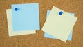 Different color post it notes pinned on cork board Royalty Free Stock Photo