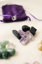 Different energy stones on a table next to your bag Royalty Free Stock Photo