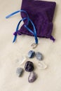 Different energy stones on a table next to your bag Royalty Free Stock Photo
