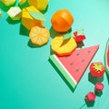 Different exotic fruits made of paper on trendy mint background