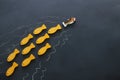 different fish swimming opposite way of identical ones. Courage and success concept. Blackboard background. Royalty Free Stock Photo