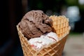 Different Flavors Chocolate, Vanilla, Strawberry Ice Cream scoops in homemade wide mouth crispy waffle cones Royalty Free Stock Photo