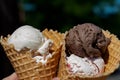 Different Flavors Chocolate, Vanilla, Strawberry Ice Cream scoops in homemade wide mouth crispy waffle cones Royalty Free Stock Photo