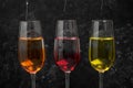 Different food coloring pouring into glasses on grey background Royalty Free Stock Photo