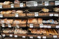 Different fresh bread on the shelves in bakery. Interior of a modern grocery store showcasing the bread aisle with a variety of