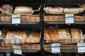 Different fresh bread on the shelves in bakery. Interior of a modern grocery store showcasing the bread aisle with a variety of