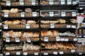 Different fresh bread on the shelves in bakery. Interior of a modern grocery store showcasing the bread aisle with a variety of